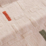 Detailed zoom of the Brick washable wool rug showcasing its textured weave and rustic warmth for modern kids' rooms.