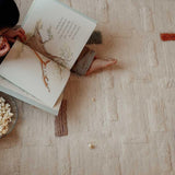 Washable wool children's rug with a structured brick pattern in warm earth tones, perfect for a grounded, cozy space.