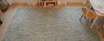 Thumbnail of a wool children’s rug with a colorful floral field pattern, soft and washable for everyday use.