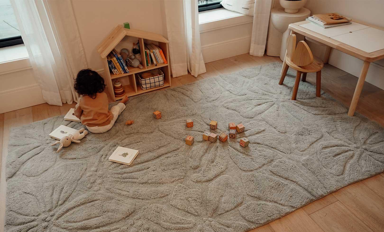 Washable wool children's rug with a vibrant floral field design, featuring colorful flowers on a soft background.