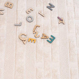 Neutral-toned, washable rug for children featuring a minimal nest design, made with non-toxic materials.