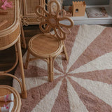 Children's room with wicker furniture and a washable wool children's rug.