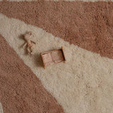 Brown toy truck and teddy bear on a pink and beige patterned nontoxic children's washable wool rug