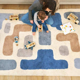 Organic washable wool area rug with a soft, neutral stacked design, ideal for modern children's rooms.