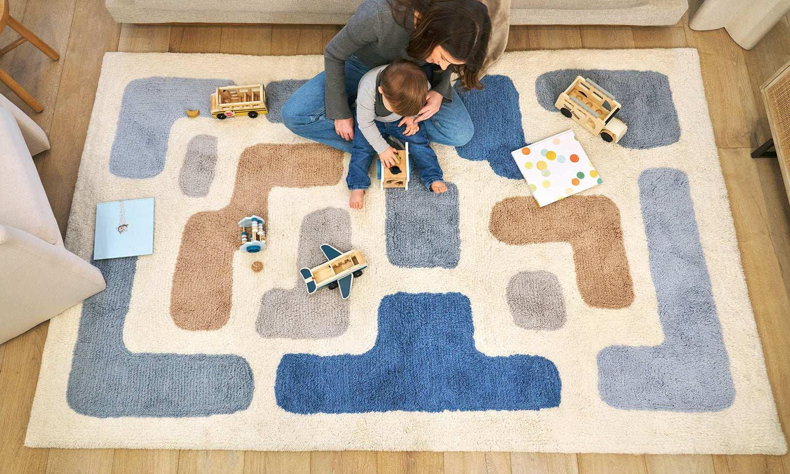 Organic washable wool area rug with a soft, neutral stacked design, ideal for modern children's rooms.