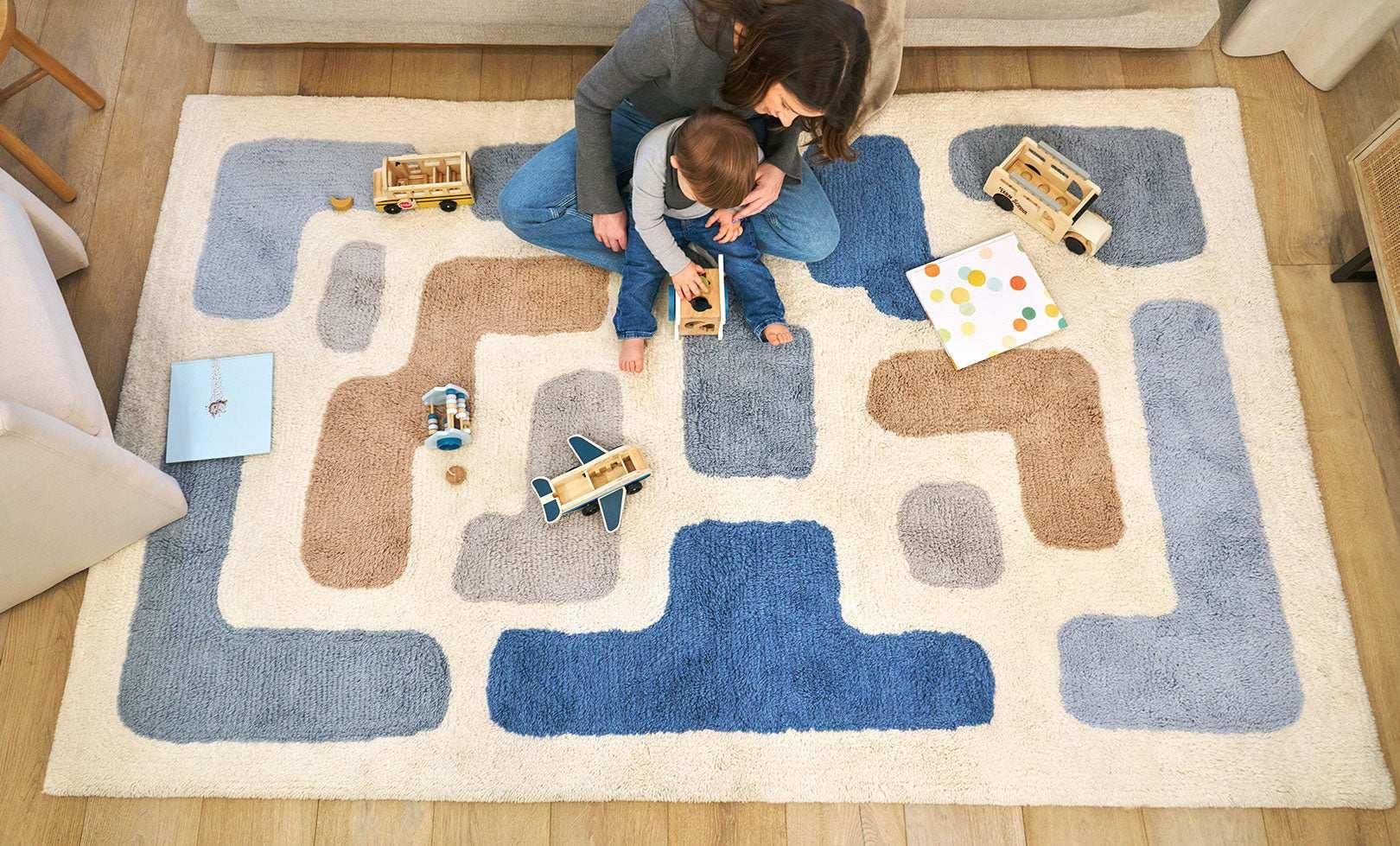 Organic washable wool area rug with a soft, neutral stacked design, ideal for modern children's rooms.