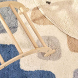 A natural wool children's rug with a stacked design, washable for convenience.