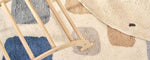 A natural wool children's rug with a stacked design, washable for convenience.