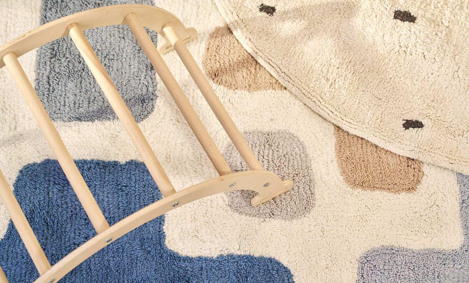 A natural wool children's rug with a stacked design, washable for convenience.