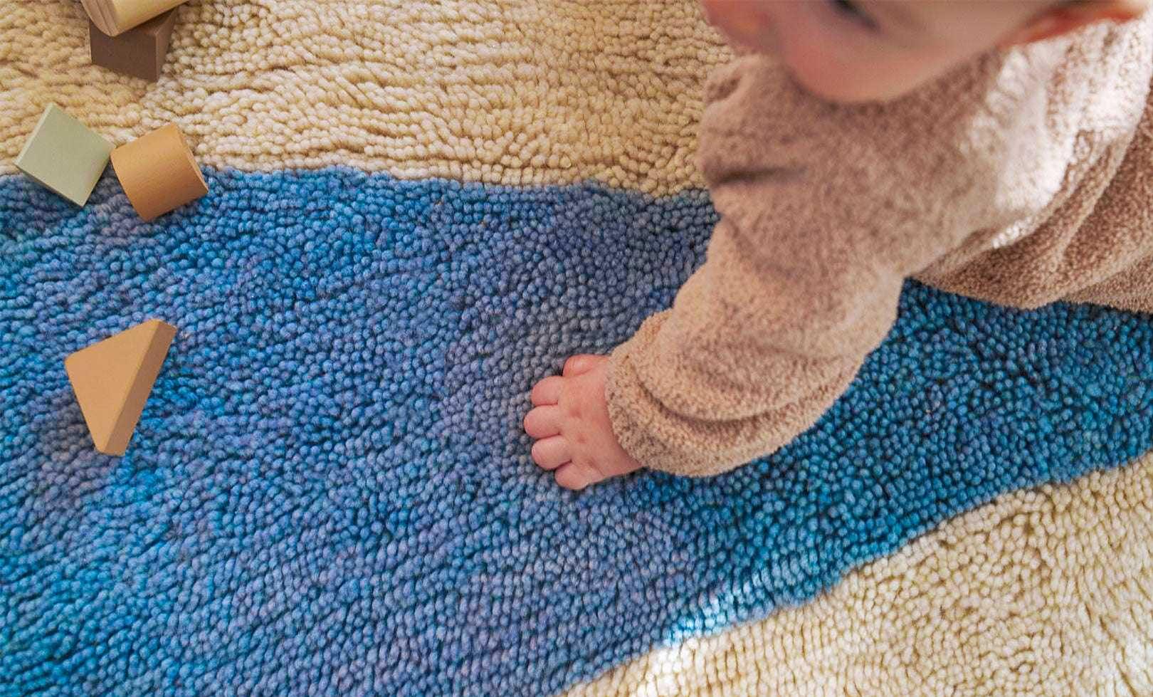 Fresh and lively wool rug featuring a bold blue pinwheel motif, perfect for active playrooms and easy cleaning.