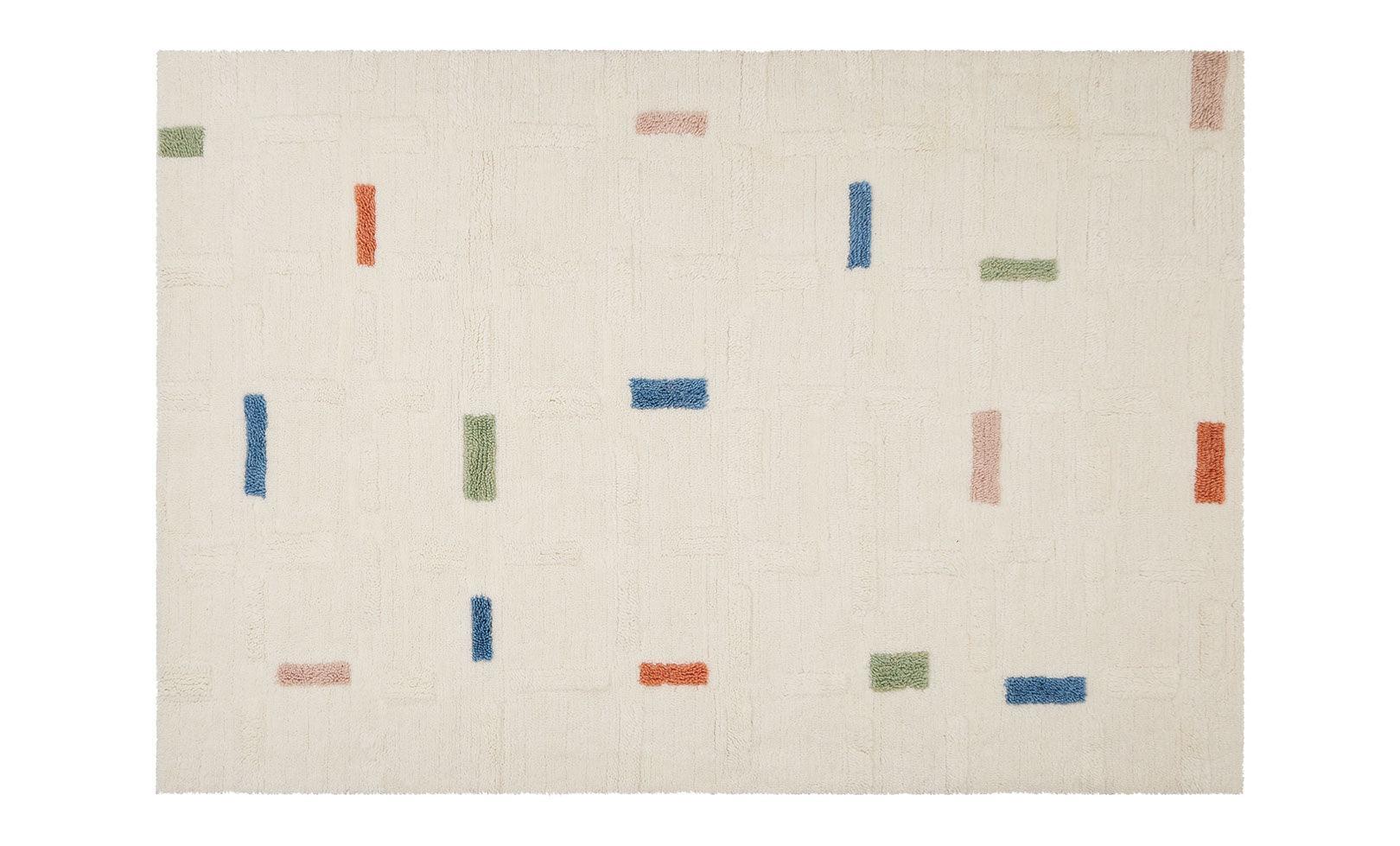 Full view of a wool children's rug with a structured brick design, crafted from soft, washable material.