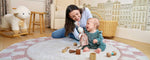 Organic and non-toxic washable nursery rug with a modern checkerboard design in soft neutral shades.