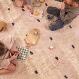 Modern black and white dotted organic washable rug for nurseries or playrooms.