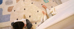 Stylish black dot rug made with organic fibers, offering a bold contrast and a washable, non-toxic foundation for kids.