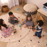 An organic, non-toxic children's rug with a dotted rust pattern, safe for kids.