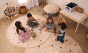An organic, non-toxic children's rug with a dotted rust pattern, safe for kids.