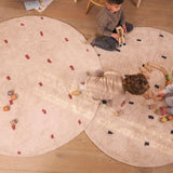 Organic, washable nursery rug with a dotted rust design that combines earthy tones with child-safe materials.