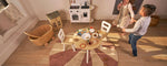 Washable wool children's rug featuring a pink pinwheel design, offering a cheerful and soft atmosphere for any room.