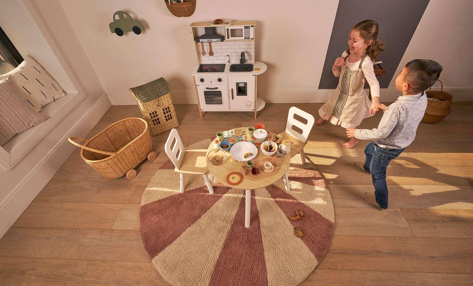 Washable wool children's rug featuring a pink pinwheel design, offering a cheerful and soft atmosphere for any room.
